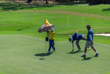 Obraz premium Caddy on fairway at country club golf course. lifestyle sport training golfing at golf club on summer holiday vacation.