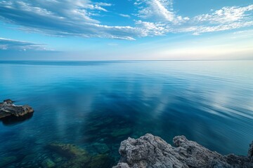 A photo showing a vast expanse of water with rocks encircling it, creating a striking landscape, Sky view of a tranquil sea brushing against a rocky coast, AI Generated