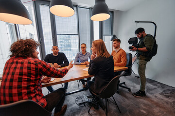 Capturing Corporate Dynamics: Videographer Films Business Meeting in Modern Office.