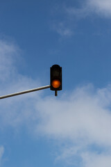 red traffic signal against a blue sky