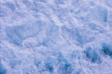 Obraz premium Aerial top down oceanic tidal waves rolling and creating foam patterns, Above Natural Water Swirl Wind Day