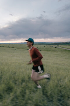 Blurred Runner in Morning Meadow