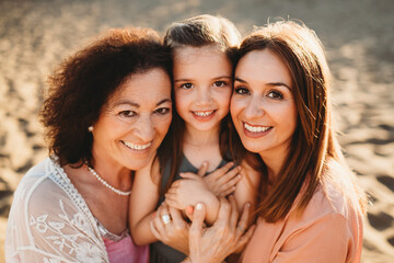 Portrait three generations beautiful Spanish women at beach