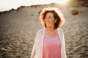Happy older woman smiling at beach in Spain