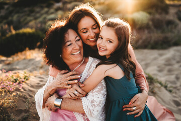 Three generations women beach summer sunset happy smiling Latin