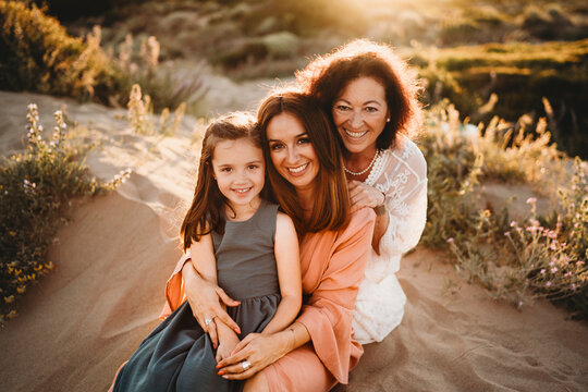 Portrait three generations women mom grandma girl beach sunset Spain