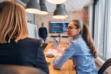 African-American businessman leads a meeting, passionately presenting a business plan to his attentive team, fostering collaboration and strategic thinking