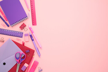 Bright and organized school supplies on a pink backdrop, perfect for educational content, back-to-school promotions