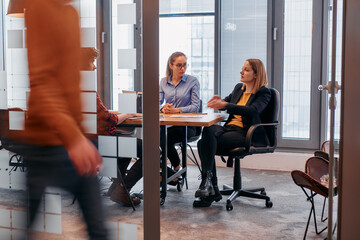 In the dynamic hustle and bustle of a business environment, a group of young business professionals...