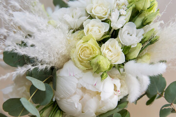 The bride's bouquet of white roses. A floral accessory for a wedding.