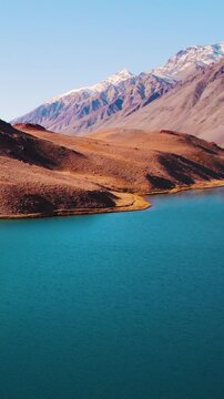 Vertical Aerial view of natural glacier lake surrounded by Himalaya mountains. Chandra Taal lake in Spiti Valley, India. Beautiful aerial view of famous Chandratal lake. Nature landscape drone shot.