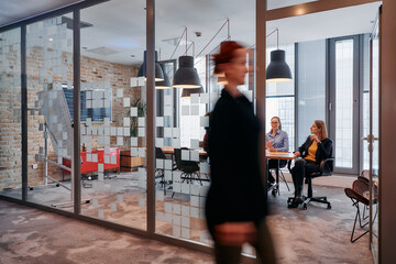 In the dynamic hustle and bustle of a business environment, a group of young business professionals...