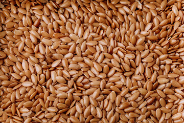 Many flax seeds as background, vegetarian and healthy diet.