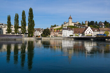 Fototapeta premium Schaffhausen, Switzerland: Reflection of the Munot medieval fortress overlooking Schaffhausen old town by the Rhine river on a sunny summer day in eastern Switzerland.