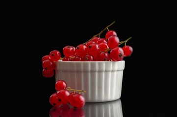 Red currants inside a white container