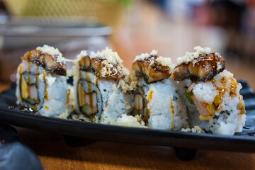 Side view of delicious sushi roll pieces on top with eel.  This is a delicious sushi roll