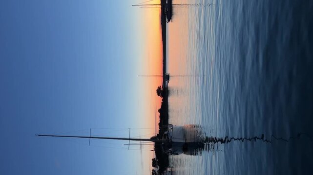 Yachts moored on buoys near the shore in the bay of Uvala Gradina near the town of Vela Luka on the island of Korcula at night time in Croatia