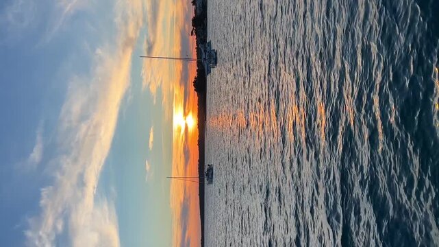 Yachts moored on buoys near the shore in the bay of Uvala Gradina near the town of Vela Luka on the island of Korcula at sunset lights in Croatia