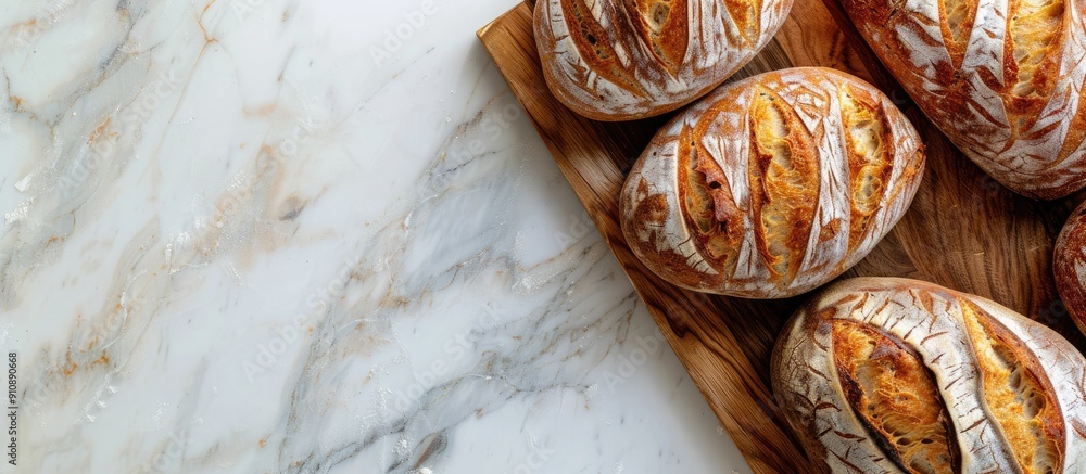 Aufkleber A high quality photo of a bakery display featuring golden rustic loaves of bread on a wooden board placed on a light background captured from above with a layout including copy space image