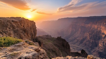 Panoramic View of Rugged Mountain Landscape at Sunset, Dramatic Cliffs and Deep Gorges with Sky Ablaze in Warm Hues of Orange and Pink