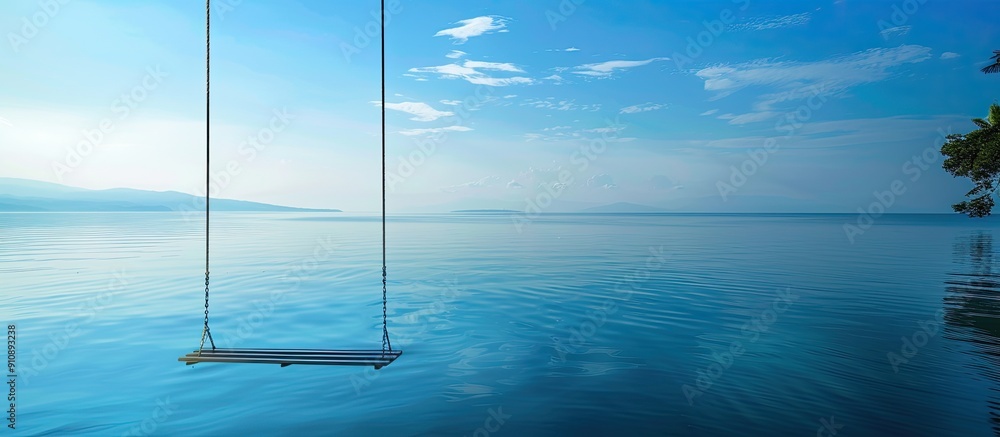 Poster serene sea view with an empty swing offering copy space image peaceful morning by the water reflecti