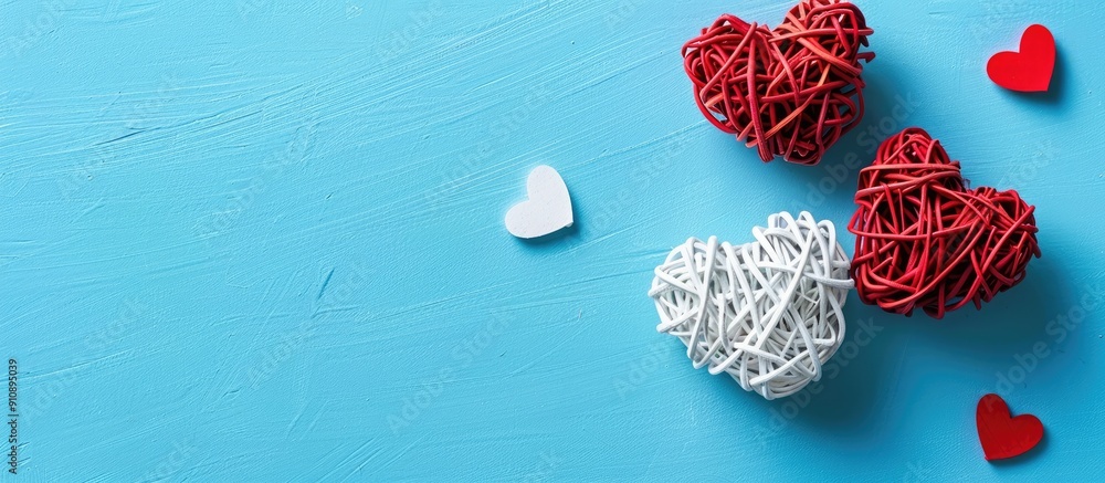 Aufkleber valentine s day themed flat lay featuring white rattan hearts with a red heart on a blue background 