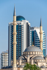 minaret of traditional Islamic mosque and tall modern skyscrapers in Grozny Chechnya