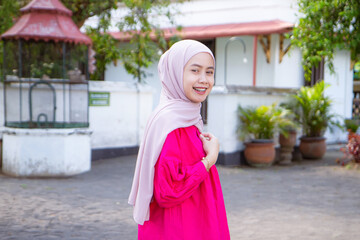 Asian Indonesian muslim tourist woman traveling inside kraton Yogyakarta sultanate palace