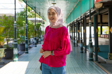 Asian Indonesian muslim tourist woman traveling inside kraton Yogyakarta sultanate palace