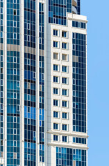 Fototapeta premium many windows and walls facade of a modern skyscraper without people