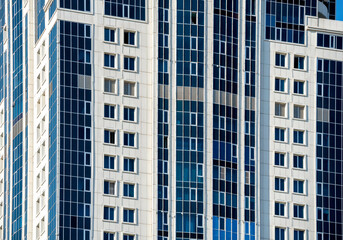 Fototapeta premium many windows and walls facade of a modern skyscraper without people