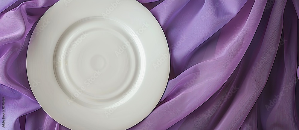 Fototapete white dinner plate showcased with a rolled purple table linen creating an elegant setting against a 