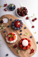 Berry Desserts Assortment, Seasonal Pastry over Bright Background