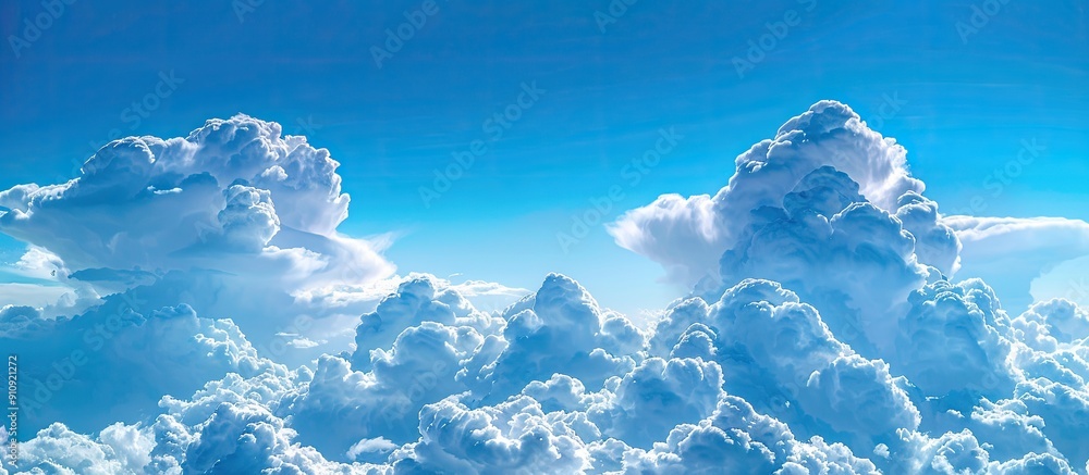 Aufkleber Picture showing stunning fluffy cumulus clouds set against a vivid blue sky with ample space for additional elements Copy space image