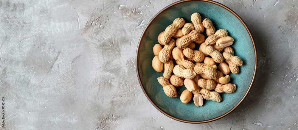 Aufkleber Top view of a plate with fresh peanuts arranged neatly in a bowl with copy space image available