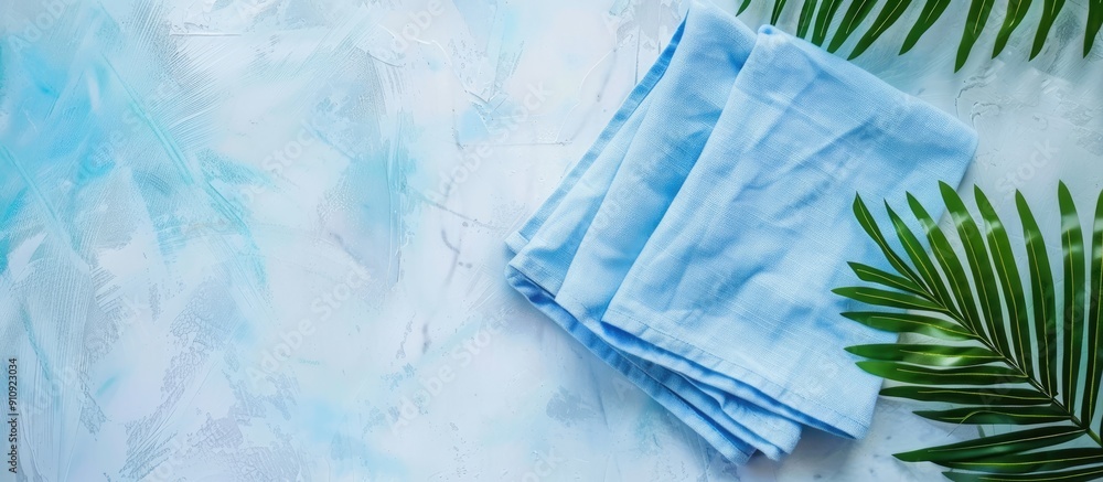 Poster a folded blue kitchen napkin isolated on a table background ideal for mockups with copy space image 