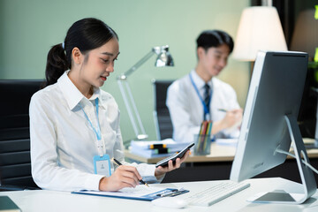 Obraz premium Asian employee working at office with laptop and documents on desk, People Work in Business Office.
