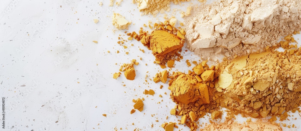 Poster Golden highlighting powders displayed on a white backdrop with empty space for adding images. Creative banner. Copyspace image