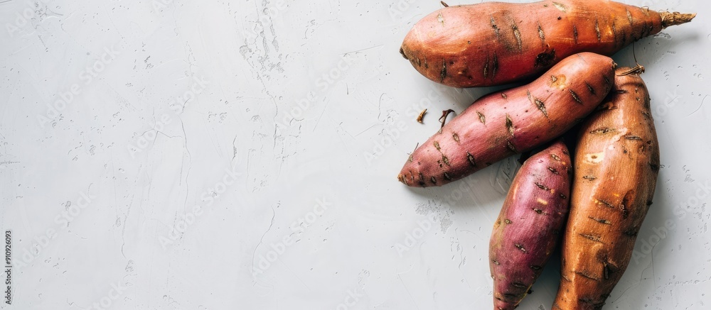 Poster sweet potato on a plain white backdrop with copy space image