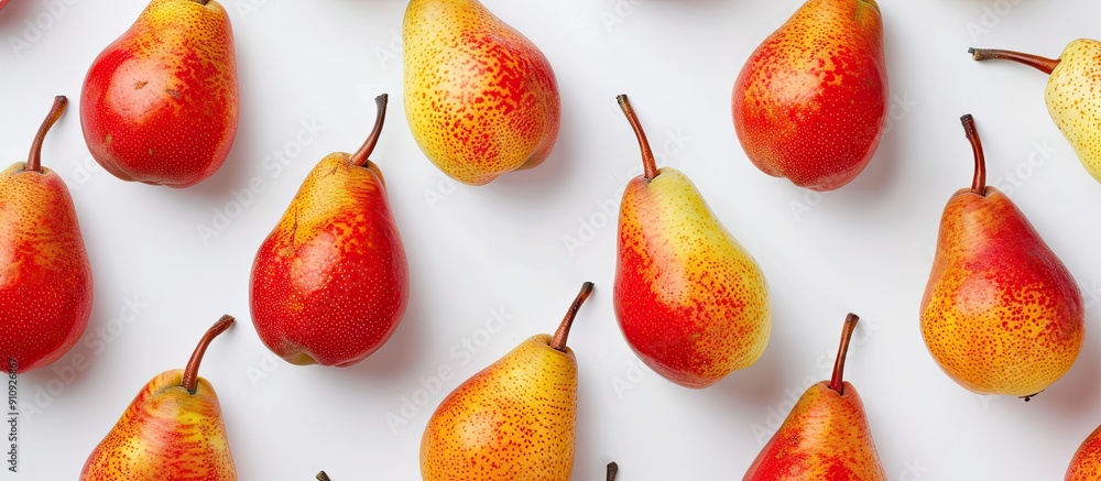 Leinwandbilder overhead view of vibrant ripe pear fruits in red and yellow shades set against a white backdrop prov