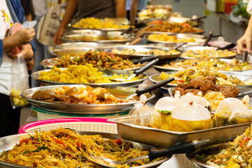 A large buffet table with many different types of food. Scene is inviting and welcoming