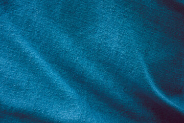 Fototapeta premium A blue fabric with a pattern of blue and white. The fabric is smooth and has a shiny appearance