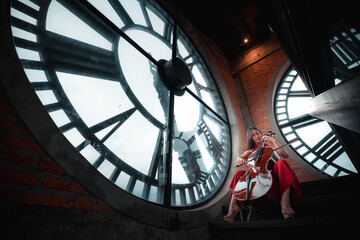 Obraz premium A woman sits in front of a clock with a cello. The clock is large and has a very old-fashioned look. The woman is dressed in red and is playing the cello. The image has a vintage