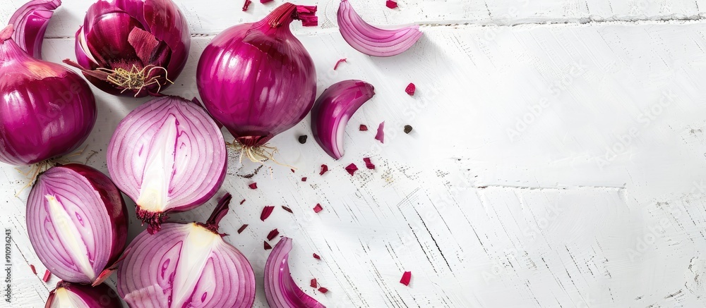 Poster Onion being sliced on a white wooden surface with space for text or images. Creative banner. Copyspace image
