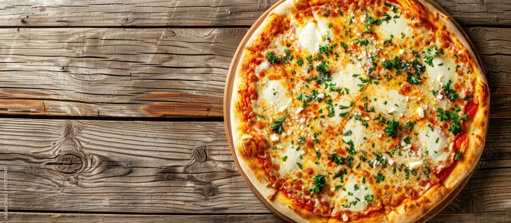Poster Top down view of a pizza with mozzarella and Parmesan cheese on a wooden surface offering ample copy space for text or images
