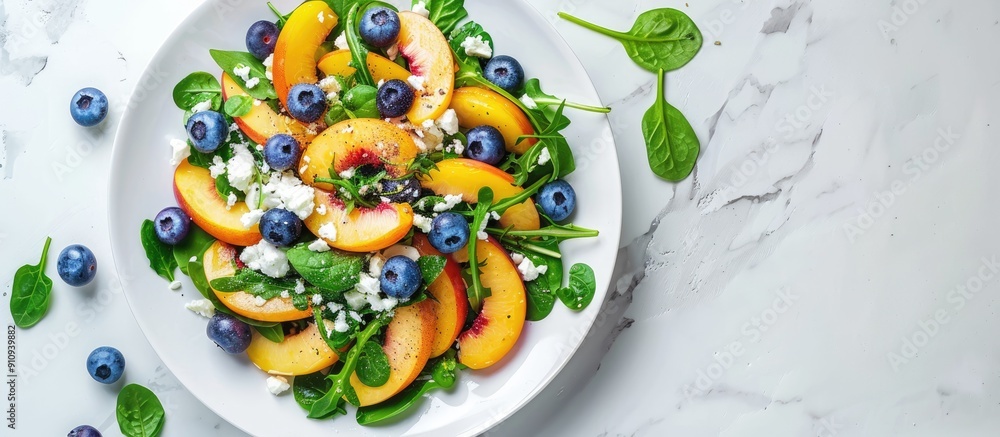 Poster healthy vegetarian salad featuring nectarines blueberries arugula spinach and feta cheese on a white