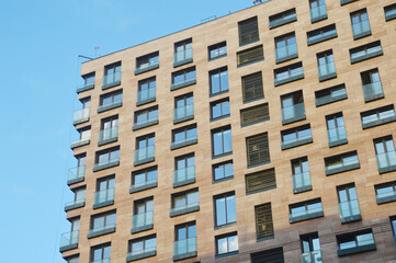 Multi-storey modern brick residential building. Building facade. Urban architecture.