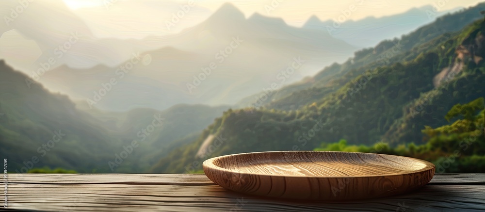 Leinwandbilder wooden plate on the table with a soft blurry mountain background perfect for your copy space image a