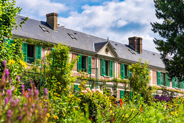 Flowered and picturesque facade of a house in Giverny's where French painter Claude Monet lived,...