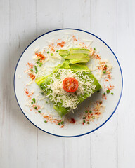 Baked potatoes with spinach bechamel and cheese.